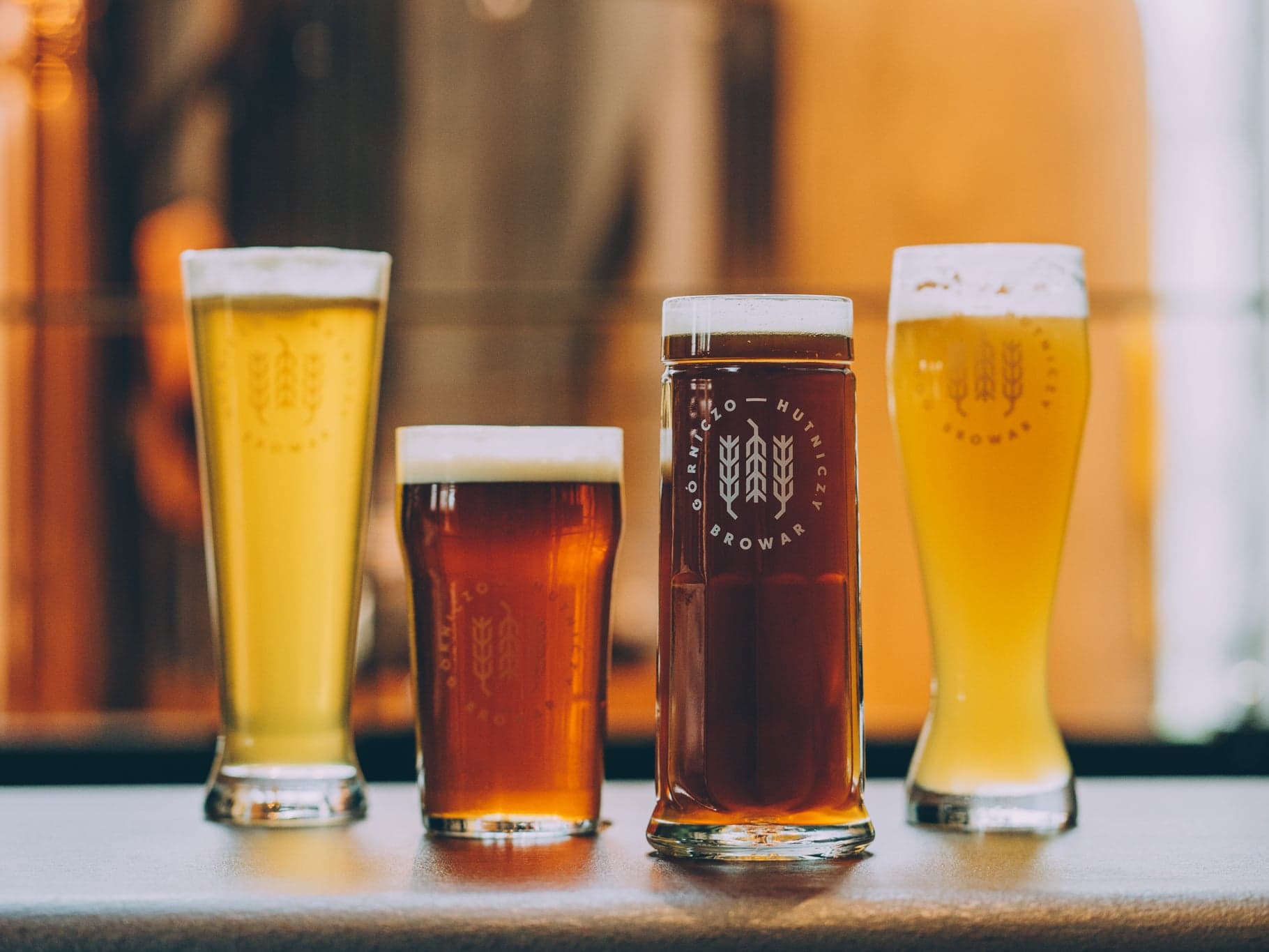 Four beers in dedicated BGH glassware: a pilsner glass, a pint, a mug and a wheat beer glass