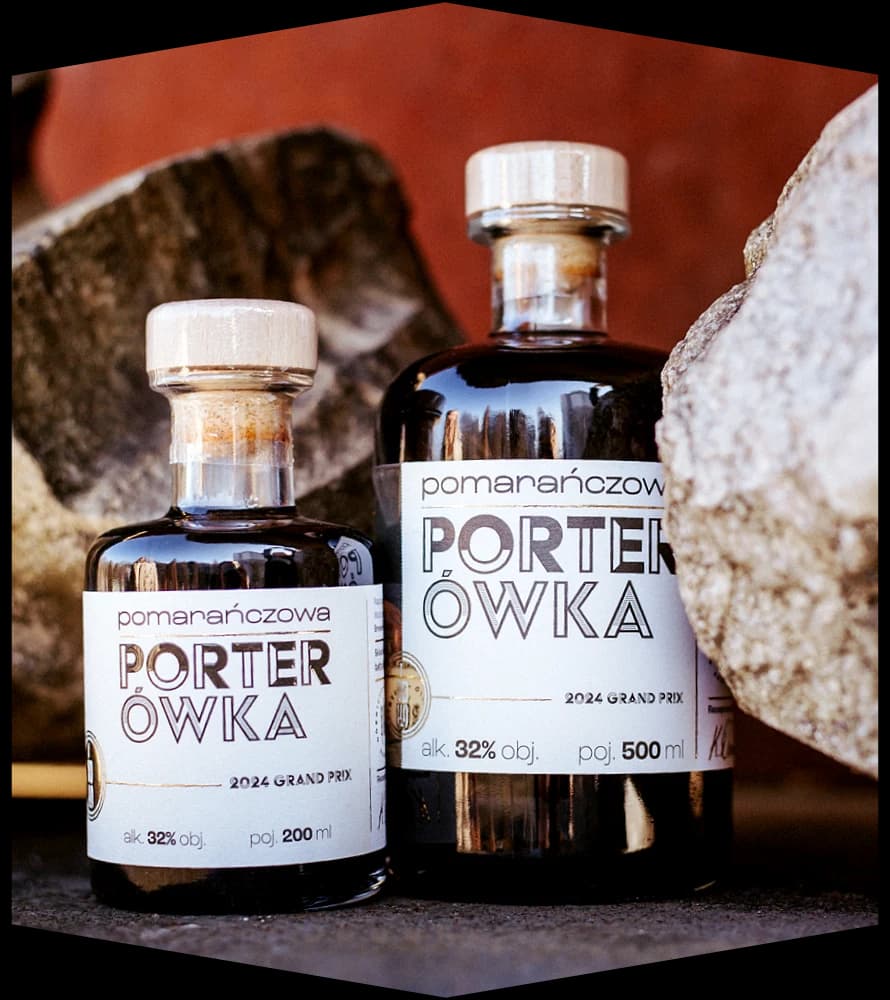 Bottles of Porterówka BGH — 200 ml and 500 ml — set among stones