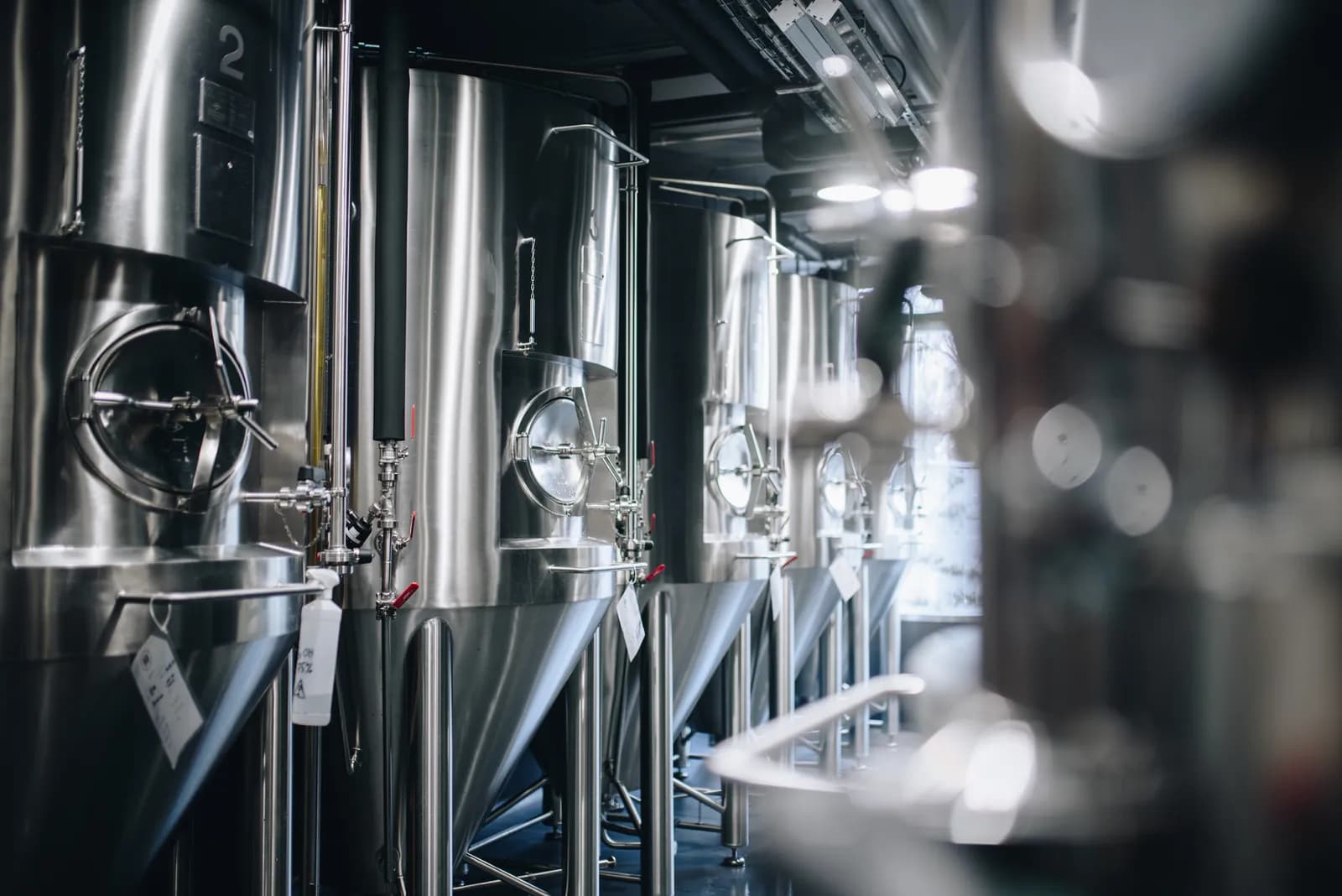 A row of stainless cylindroconical tanks in the fermentation and maturation area